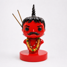 Chota Pandit with two unlit incense sticks seated in the metal-sleeved slots