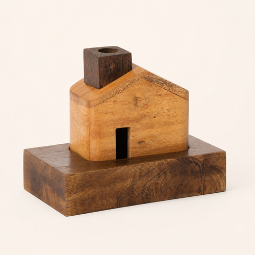 Kutir wooden incense house seated on its recessed base, plain background